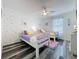 Charming ' bedroom featuring twin beds, soft decor, and a ceiling fan at 8518 La Isla Dr, Kissimmee, FL 34747