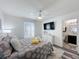 Comfortable bedroom with bathroom access, a ceiling fan, and neutral tones at 8518 La Isla Dr, Kissimmee, FL 34747