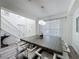 Bright dining room with modern chandelier, large wood table and staircase at 8518 La Isla Dr, Kissimmee, FL 34747