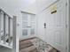 Clean entryway features wood-look floors and direct access to stairway and exterior doors at 8518 La Isla Dr, Kissimmee, FL 34747