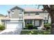 Beautiful home featuring a well-maintained lawn, mature landscaping, and a two-car garage at 8518 La Isla Dr, Kissimmee, FL 34747