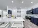 Bright, modern kitchen features an island with bar seating and stainless steel appliances at 8518 La Isla Dr, Kissimmee, FL 34747