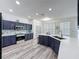 Spacious kitchen with stainless steel appliances, quartz countertops, and hardwood style floors at 8518 La Isla Dr, Kissimmee, FL 34747