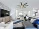 Open-concept living room has tile accent wall and flows seamlessly to dining area at 8518 La Isla Dr, Kissimmee, FL 34747