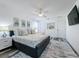 Large bedroom boasts cool colors, decorative pillows, and a gray and white area rug over plank flooring at 8518 La Isla Dr, Kissimmee, FL 34747
