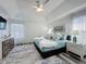Large Primary bedroom with plank flooring, large windows with decorative curtains and a light paint at 8518 La Isla Dr, Kissimmee, FL 34747