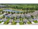 This aerial showcases a neighborhood with a scenic pond view, surrounded by lush greenery and well-spaced homes at 10172 Storey Grove Way, Winter Garden, FL 34787