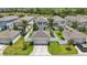 This aerial view shows a well-maintained home with a two-car garage and a green lawn, fenced for privacy at 10172 Storey Grove Way, Winter Garden, FL 34787