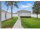 A neatly landscaped backyard featuring a storage shed, manicured lawn, and privacy fence at 10172 Storey Grove Way, Winter Garden, FL 34787