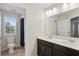This bathroom features double sinks, a large mirror, and a shower with a curtain at 10172 Storey Grove Way, Winter Garden, FL 34787