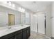 The modern bathroom is equipped with double sinks, modern fixtures and a glass shower at 10172 Storey Grove Way, Winter Garden, FL 34787