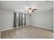Spacious bedroom features a ceiling fan, luxury vinyl flooring and large window at 10172 Storey Grove Way, Winter Garden, FL 34787
