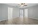 The large main bedroom boasts luxury vinyl flooring, ceiling fan and multiple doorways at 10172 Storey Grove Way, Winter Garden, FL 34787
