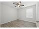 A serene bedroom offers neutral walls, a ceiling fan and luxury vinyl flooring at 10172 Storey Grove Way, Winter Garden, FL 34787