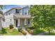 Charming two-story home with a well-manicured front yard and covered porch with stone pillar accents at 10172 Storey Grove Way, Winter Garden, FL 34787