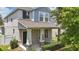 Charming two-story home with a welcoming front porch, showcasing a mix of textures and colors at 10172 Storey Grove Way, Winter Garden, FL 34787