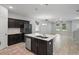 Open kitchen with a center island and stainless steel appliances connecting to the living space at 10172 Storey Grove Way, Winter Garden, FL 34787