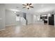 Open-concept living space featuring tile flooring, a ceiling fan, and stairs leading to the second floor at 10172 Storey Grove Way, Winter Garden, FL 34787