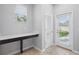 Mud room featuring a modern work station, closet, tile floors, and access to the backyard at 10172 Storey Grove Way, Winter Garden, FL 34787