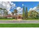 Charming Win-Gate Clubhouse featuring a welcoming entrance and beautifully landscaped grounds at 10849 William Tell Dr, Orlando, FL 32821