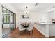 Bright dining area features hardwood floors and sliding glass doors to lanai at 10849 William Tell Dr, Orlando, FL 32821