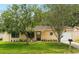 Charming single-story home with well-maintained lawn and mature trees in a tranquil setting at 10849 William Tell Dr, Orlando, FL 32821