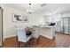 Bright kitchen and dining area features hardwood floors, granite countertops and stainless steel appliances at 10849 William Tell Dr, Orlando, FL 32821