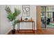 A stylish table against a wall with decor leading to a screened in lanai with seating at 10849 William Tell Dr, Orlando, FL 32821