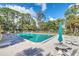 Large community pool surrounded by lush greenery and comfortable lounge seating at 10849 William Tell Dr, Orlando, FL 32821
