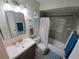 Bright bathroom with white floral shower curtain and updated vanity at 1108 Northlake Dr # 1108, Sanford, FL 32773