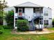 Well-maintained condo with stairs leading to the front door and surrounding greenery at 1108 Northlake Dr # 1108, Sanford, FL 32773