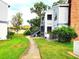 Exterior view of condo with a staircase, lush greenery, and well-maintained landscaping at 1108 Northlake Dr # 1108, Sanford, FL 32773