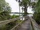 Scenic view of a wooden dock leading to a serene lake surrounded by lush greenery at 1108 Northlake Dr # 1108, Sanford, FL 32773