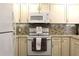Charming kitchen with updated appliances, backsplash, and ample storage space, ideal for culinary enthusiasts at 1108 Northlake Dr # 1108, Sanford, FL 32773