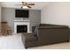 Cozy living room features a fireplace, TV, neutral paint and comfortable seating, ideal for relaxing and entertaining at 1108 Northlake Dr # 1108, Sanford, FL 32773