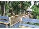 Elevated walkway leading to a house with tropical palm trees and lush greenery all around at 1108 Northlake Dr # 1108, Sanford, FL 32773