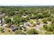 Wide aerial shot of a home in a neighborhood surrounded by lush greenery and other houses at 1119 W 7Th St, Sanford, FL 32771