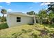Exterior view of the backyard featuring a well-maintained lawn and a covered porch at 1119 W 7Th St, Sanford, FL 32771
