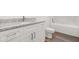 Modern bathroom featuring a granite countertop, white cabinets, and a separate tub at 1119 W 7Th St, Sanford, FL 32771