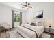 Stylishly furnished bedroom featuring a comfortable bed, an armchair, and ample natural light at 1119 W 7Th St, Sanford, FL 32771