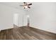 Bedroom with hardwood floors, ceiling fan, and doors for closet and bathroom at 1119 W 7Th St, Sanford, FL 32771