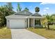Charming single-story home with a well-manicured lawn, paved driveway, and attached garage at 1119 W 7Th St, Sanford, FL 32771