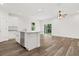 Modern kitchen featuring granite countertops, stainless steel appliances and wood grain tile at 1119 W 7Th St, Sanford, FL 32771