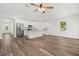 Open floor plan showing kitchen with granite countertops, stainless steel appliances and wood grain tile at 1119 W 7Th St, Sanford, FL 32771