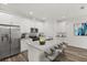 Staged bright kitchen featuring stainless steel appliances, granite countertops, and ample cabinet space at 1119 W 7Th St, Sanford, FL 32771