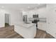 Modern kitchen with white cabinetry, stainless steel appliances, and a spacious island with granite countertops at 1119 W 7Th St, Sanford, FL 32771