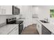 Close up on the kitchen featuring granite countertops, stainless steel appliances, and ample cabinet space at 1119 W 7Th St, Sanford, FL 32771