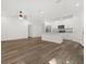 Open floor plan showing kitchen with granite countertops, stainless steel appliances and wood grain tile at 1119 W 7Th St, Sanford, FL 32771
