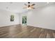 Spacious and bright living room with wood grain tile and sliding glass doors to the backyard at 1119 W 7Th St, Sanford, FL 32771