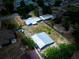 Aerial view of the house and outbuilding on a lot with mature trees at 11624 Ocklawaha Dr, Leesburg, FL 34788